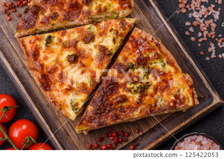 Delicious fresh quiche with broccoli, cheese, spices and herbs Delicious fresh quiche with broccoli, cheese, spices and herbs 125422053
