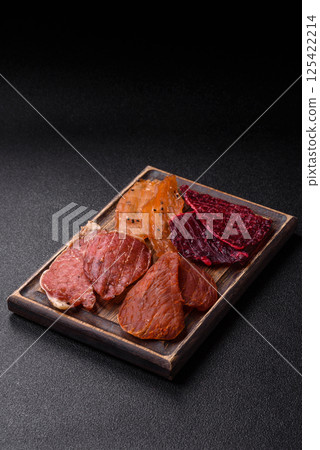 Jerky, dried pork meat with salt and spices 125422214