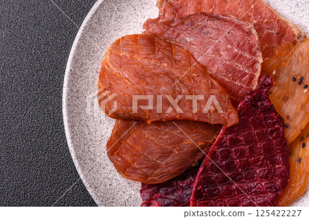 Jerky, dried pork meat with salt and spices 125422227