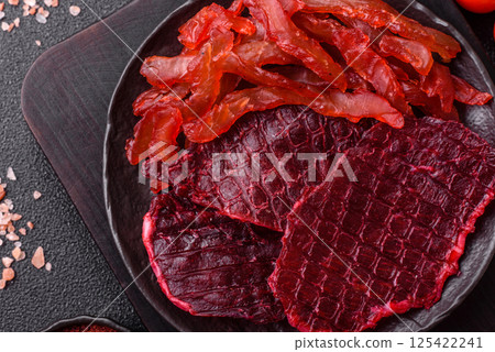 Dried beef slices, jerky, with cherry or plum flavor, salt and spices 125422241