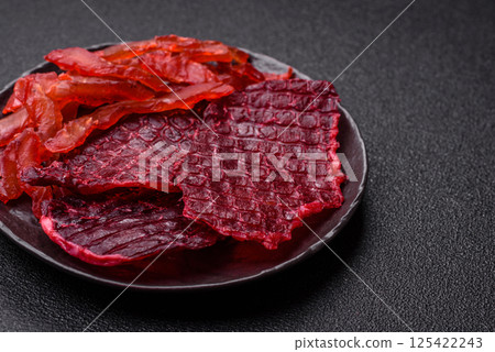 Dried beef slices, jerky, with cherry or plum flavor, salt and spices Dried beef slices, jerky, with cherry or plum flavor, salt and spices 125422243