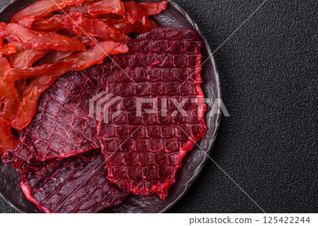 Dried beef slices, jerky, with cherry or plum flavor, salt and spices Dried beef slices, jerky, with cherry or plum flavor, salt and spices 125422244