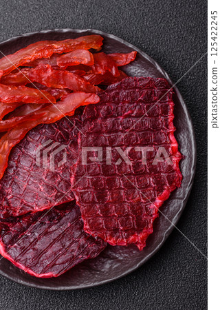 Dried beef slices, jerky, with cherry or plum flavor, salt and spices Dried beef slices, jerky, with cherry or plum flavor, salt and spices 125422245