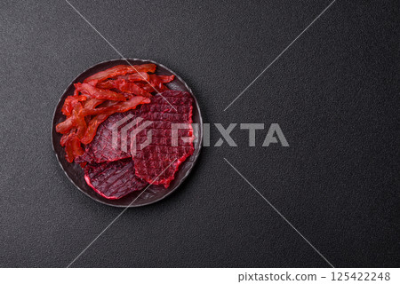 Dried beef slices, jerky, with cherry or plum flavor, salt and spices 125422248