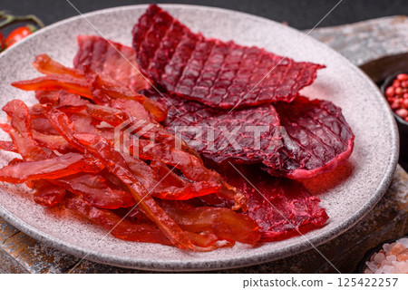 Dried beef slices, jerky, with cherry or plum flavor, salt and spices Dried beef slices, jerky, with cherry or plum flavor, salt and spices 125422257