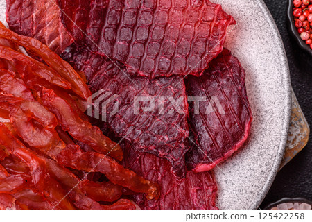 Dried beef slices, jerky, with cherry or plum flavor, salt and spices Dried beef slices, jerky, with cherry or plum flavor, salt and spices 125422258