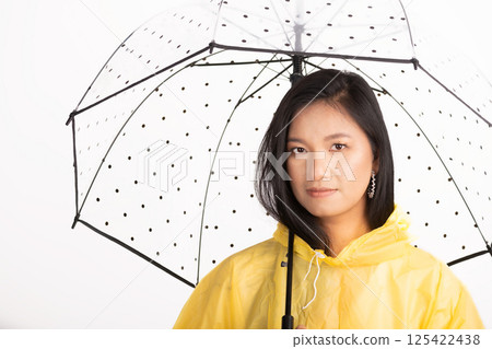 Asian woman with yellow raincoat and transparent umbrella 125422438