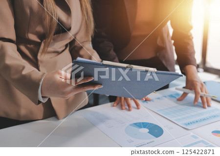Accounting company provide finance and taxation planning for profitable cash flow, Auditor and accountant team working in office, analyze financial data and accounting record with calculator.Insight 125422871