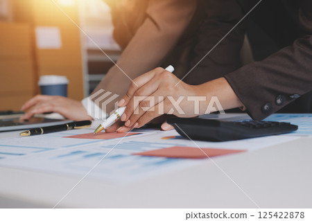 Accounting company provide finance and taxation planning for profitable cash flow, Auditor and accountant team working in office, analyze financial data and accounting record with calculator.Insight Accounting company provide finance and taxation planning for profitable cash flow, Auditor and accountant team working in office, analyze financial data and accounting record with calculator.Insight 125422878