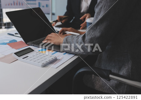 Accounting company provide finance and taxation planning for profitable cash flow, Auditor and accountant team working in office, analyze financial data and accounting record with calculator.Insight Accounting company provide finance and taxation planning for profitable cash flow, Auditor and accountant team working in office, analyze financial data and accounting record with calculator.Insight 125422891
