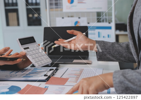 Accounting company provide finance and taxation planning for profitable cash flow, Auditor and accountant team working in office, analyze financial data and accounting record with calculator.Insight 125422897