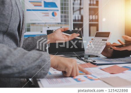 Accounting company provide finance and taxation planning for profitable cash flow, Auditor and accountant team working in office, analyze financial data and accounting record with calculator.Insight 125422898