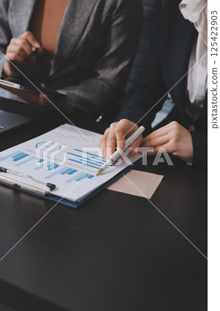 Accounting company provide finance and taxation planning for profitable cash flow, Auditor and accountant team working in office, analyze financial data and accounting record with calculator.Insight Accounting company provide finance and taxation planning for profitable cash flow, Auditor and accountant team working in office, analyze financial data and accounting record with calculator.Insight 125422903