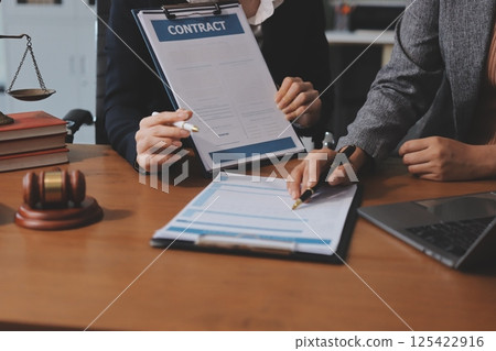 Judge gavel with Justice lawyers having team meeting at law firm background. Concepts of Law and Legal services. 125422916