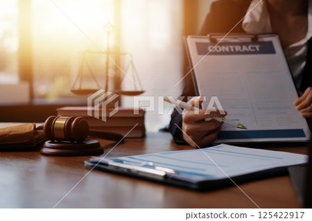 Judge gavel with Justice lawyers having team meeting at law firm background. Concepts of Law and Legal services. Judge gavel with Justice lawyers having team meeting at law firm background. Concepts of Law and Legal services. 125422917