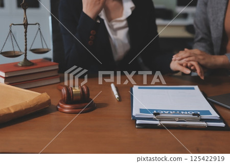 Judge gavel with Justice lawyers having team meeting at law firm background. Concepts of Law and Legal services. 125422919