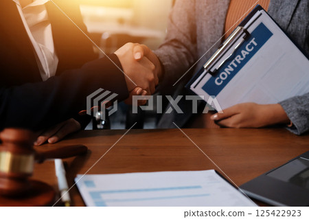 Judge gavel with Justice lawyers having team meeting at law firm background. Concepts of Law and Legal services. 125422923