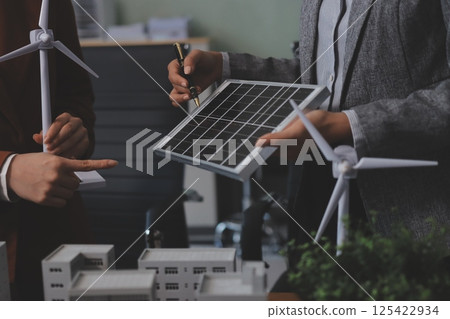Discussion among businesspeople on the latest developments in solar cell panel technology and Solar Energy Environment city Concept. Discussion among businesspeople on the latest developments in solar cell panel technology and Solar Energy Environment city Concept. 125422934