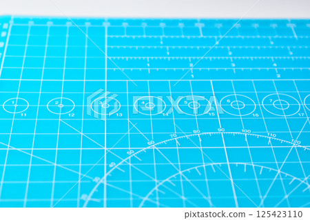blue cutting mat board on white background with line and scale measure guide pattern for art design 125423110