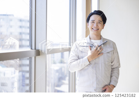 Portrait of a man wearing work clothes Portrait of a man wearing work clothes 125423182