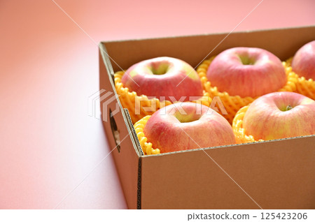 beautiful pink apple in the box on pink background 125423206