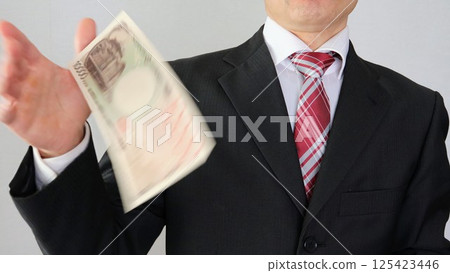 Businessman throwing banknotes 125423446