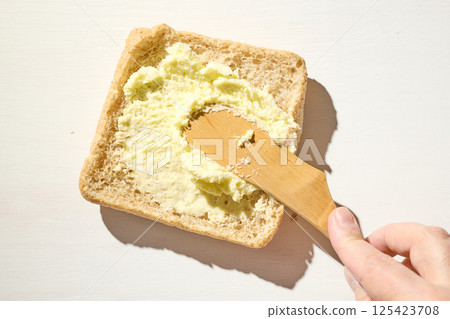 bread slice with whipped butter smear bread slice with whipped butter smear 125423708
