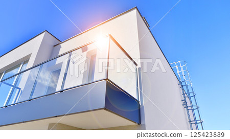 Terraced family homes in newly developed housing estate. The real estate market in the suburbs. New single family houses in a new development area. Residential homes with modern facade.  125423889