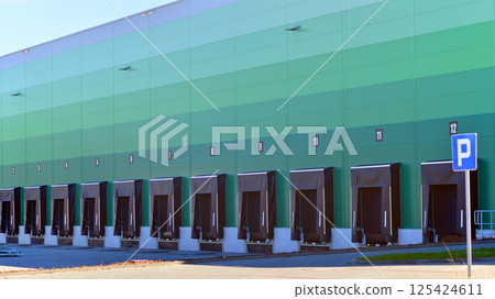 Facade of an industrial building and warehouse. Empty platforms at a distribution center.   125424611