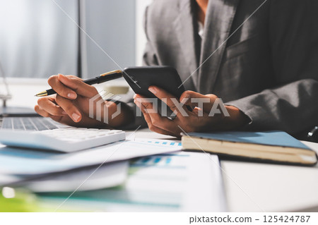 Working from home, Closeup business woman using laptop computer and analyzing financial report. Working from home, Closeup business woman using laptop computer and analyzing financial report. 125424787