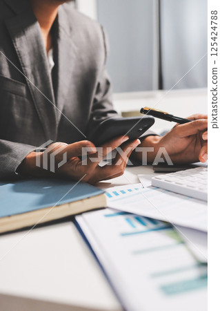 Working from home, Closeup business woman using laptop computer and analyzing financial report. 125424788