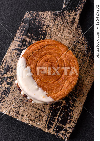 Round sweet New York roll croissant with pistachio cream filling Round sweet New York roll croissant with pistachio cream filling 125425232