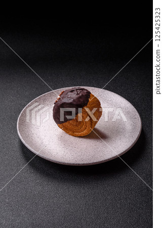 Round sweet New York roll croissant with chocolate cream filling 125425323