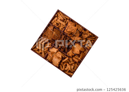 Crispy homemade brown bread chips with seeds and grains Crispy homemade brown bread chips with seeds and grains 125425636