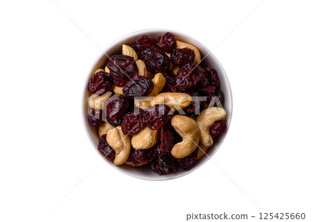 Mixture of roasted cashews and dried cranberries Mixture of roasted cashews and dried cranberries 125425660
