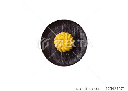 Round sweet tart of yellow color with citrus and passion fruit flavor 125425671