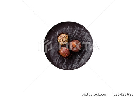 Homemade chocolate candies with different fillings and sprinkles 125425683