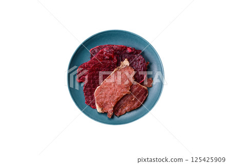 Jerky, dried pork meat slices with salt and spices Jerky, dried pork meat slices with salt and spices 125425909