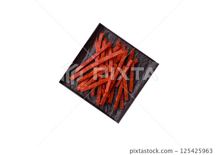 Jerky dried fish sticks with salt and spices 125425963