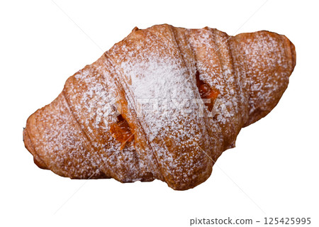 Sweet fresh crispy croissant with fruit filling 125425995