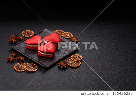 Red macaroons in the shape of a heart, sweets for the holiday of Valentine's Day Red macaroons in the shape of a heart, sweets for the holiday of Valentine's Day 125426223