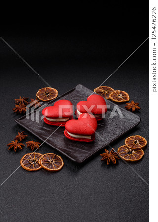 Red macaroons in the shape of a heart, sweets for the holiday of Valentine's Day 125426226
