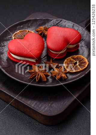 Red macaroons in the shape of a heart, sweets for the holiday of Valentine's Day 125426238