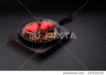 Red macaroons in the shape of a heart, sweets for the holiday of Valentine's Day 125426239