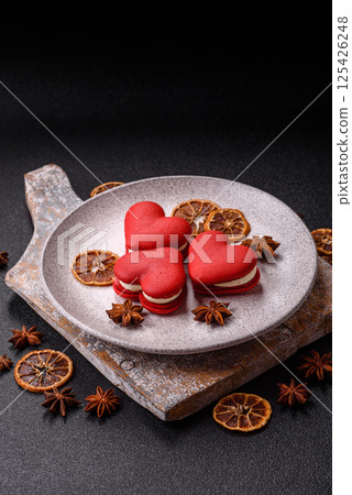 Red macaroons in the shape of a heart, sweets for the holiday of Valentine's Day Red macaroons in the shape of a heart, sweets for the holiday of Valentine's Day 125426248