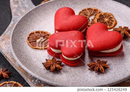 Red macaroons in the shape of a heart, sweets for the holiday of Valentine's Day Red macaroons in the shape of a heart, sweets for the holiday of Valentine's Day 125426249