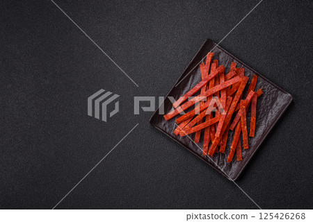 Jerky dried fish sticks with salt and spices 125426268