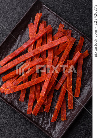 Jerky dried fish sticks with salt and spices Jerky dried fish sticks with salt and spices 125426275