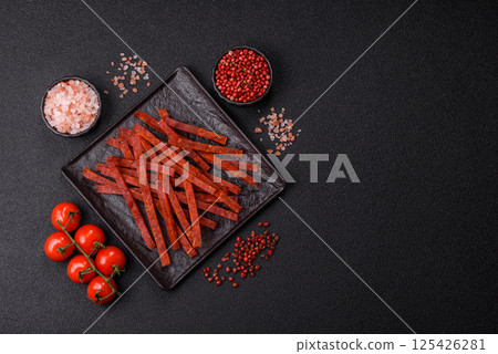 Jerky dried fish sticks with salt and spices 125426281