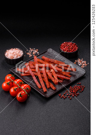 Jerky dried fish sticks with salt and spices 125426283